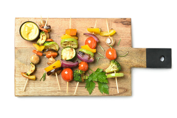 Board with tasty vegetable skewers on white background - Photo, Image