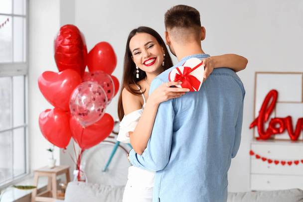 Beautiful young couple celebrating Valentine's Day at home - Foto, Imagem