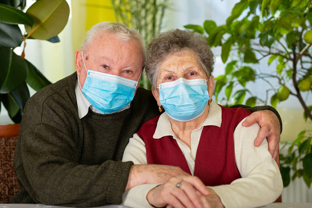 Senior  couple  with face mask at home,  self isolation - Photo, image