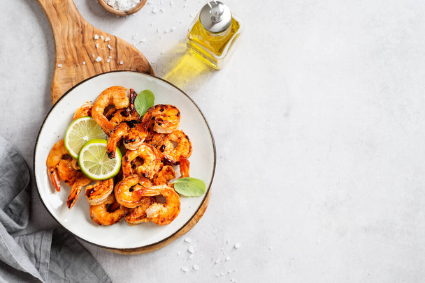 Grilled tiger shrimps with spice and lime. Light gray background, top view. Space for text - Fotó, kép