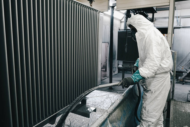 Factory, staff wear chemical protective clothing at work. Paint spraying. - Photo, Image