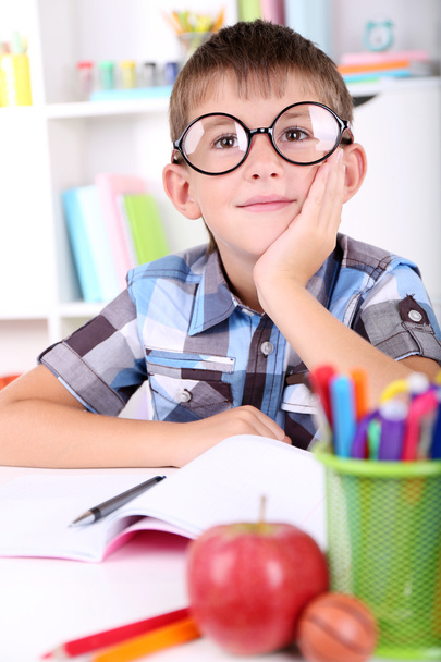 Schoolboy sitting at table in classroom - Photo, image