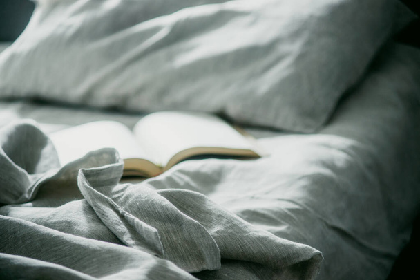 open book on the bed - 写真・画像