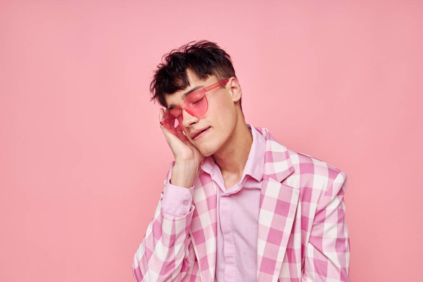 pretty man pink glasses checkered jacket fashion posing isolated background unaltered - Фото, зображення