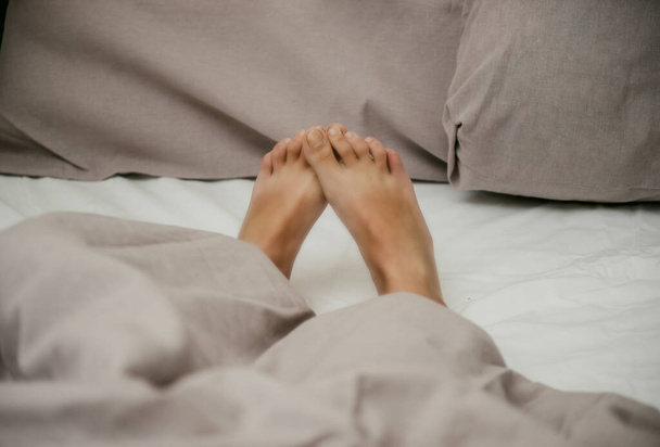 little baby feet on light bedding close-up - Φωτογραφία, εικόνα