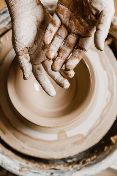 Female ceramist hands sculpt clay dishes - Photo, Image