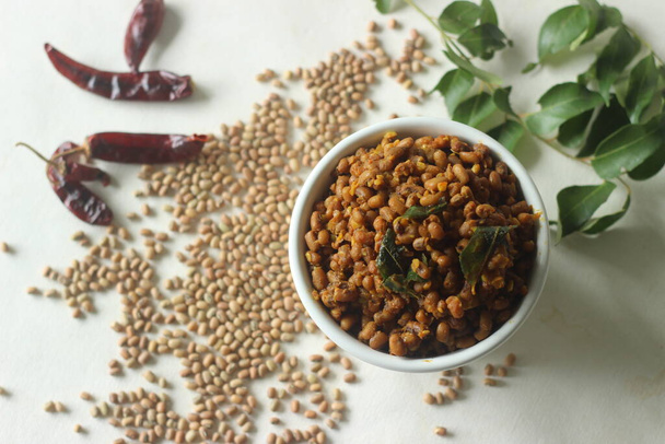 Boiled red cowpea beans stir fried with shallots and garlic. Popular side dish for meals in Kerala commonly called Stir fried Vanpayar. Shot on white background - Photo, Image