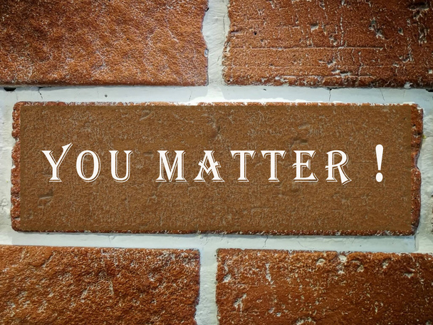 Texture of an old red brick wall with cement joints with text. You matter. - Foto, Imagem