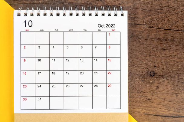 The October 2022 desk calendar on wooden background. - Zdjęcie, obraz
