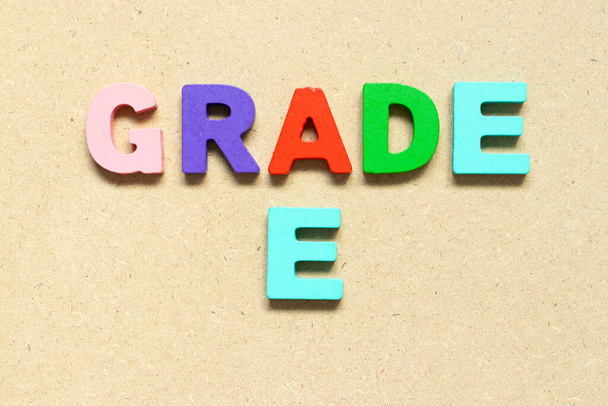 Color alphabet letter with word grade E on wood background - Φωτογραφία, εικόνα