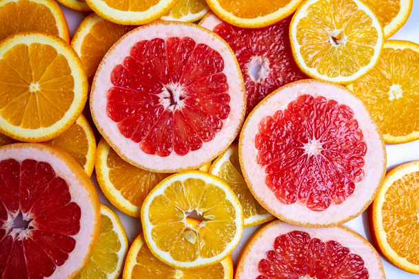 Slises of different citruses on the white background. Close-up of slised citruses. - Photo, Image