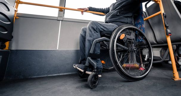 Person with a physical disability inside public transport with an accessible ramp. - Foto, Imagen