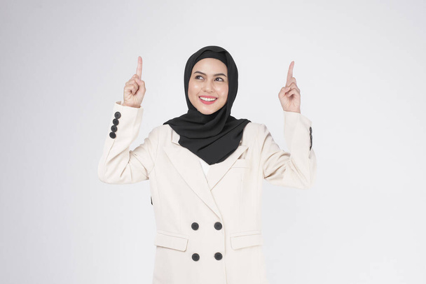 Portrait of young smiling muslim businesswoman wearing suit with hijab over white background studio.	 - Foto, imagen