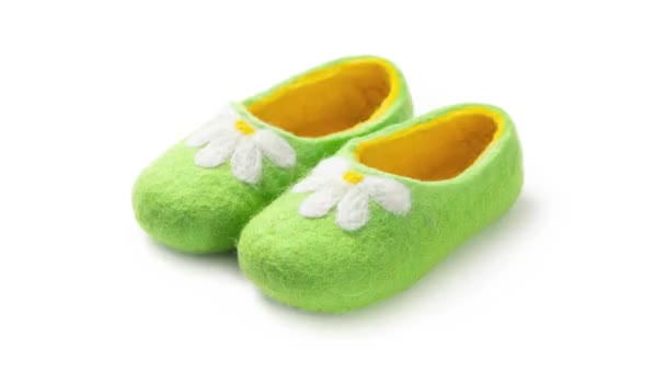 Children's slippers made of felt on a white background - Footage, Video