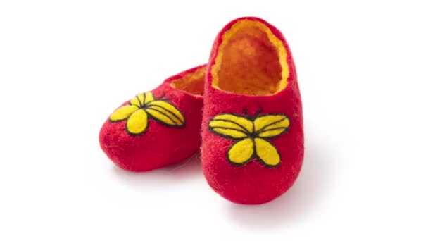 Children's slippers made of felt on a white background - Footage, Video