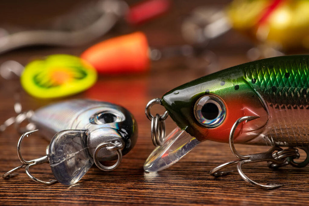 Colorful fishing lures, wobbler, spinner, on wood desk different fishing baits - Photo, image