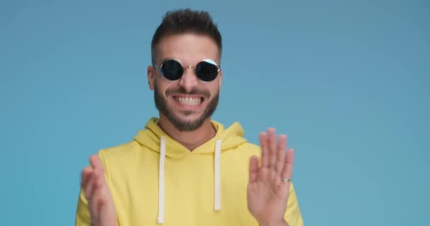 sexy casual man feeling excited, clapping his hands, wearing sunglasses and gesturing good job - Video