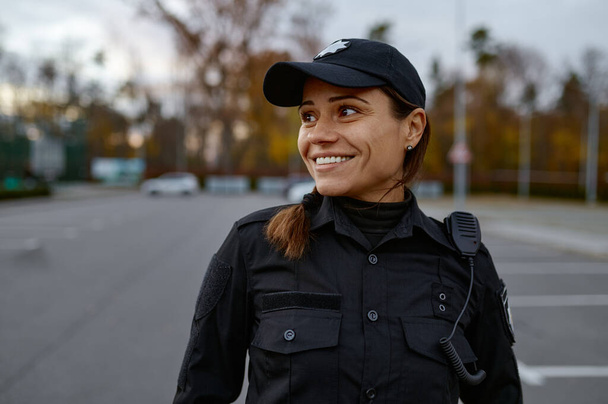 Portrait of smiling police woman on street - Φωτογραφία, εικόνα