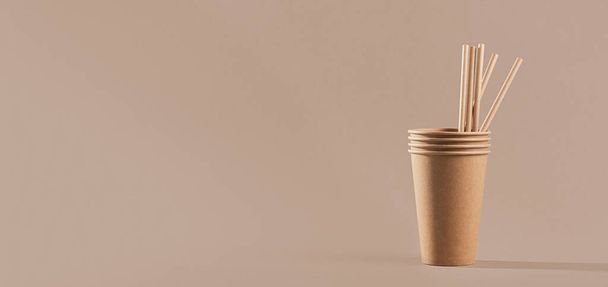 Disposable paper tableware. Cups and straws on beige background. Plastic free and zero waste concept. - Photo, Image