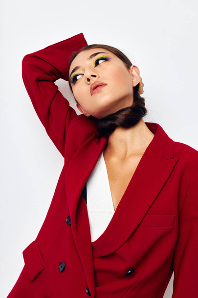 beautiful brunette bright makeup red jacket posing light background unaltered - Foto, Imagem