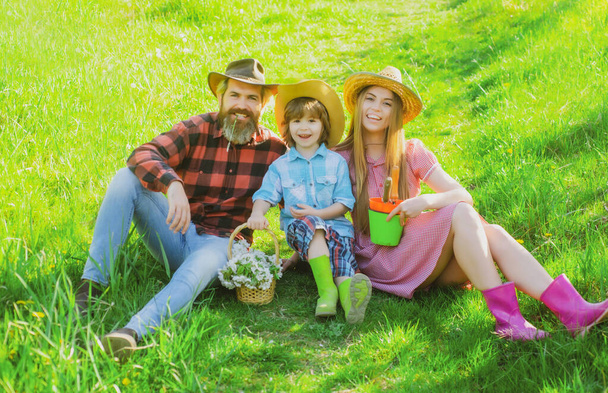 Family gardener in garden or park. Parenthood together leisure concept. - Photo, Image