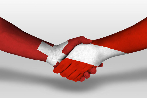 Handshake between austria and switzerland flags painted on hands, illustration with clipping path. - Photo, Image
