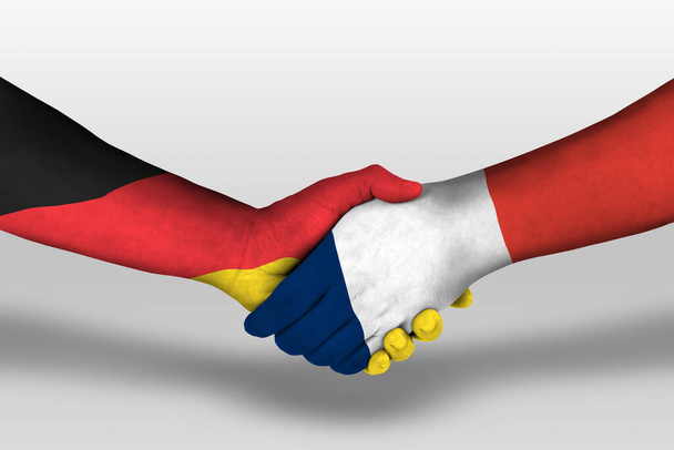 Handshake between france and germany flags painted on hands, illustration with clipping path. - Valokuva, kuva