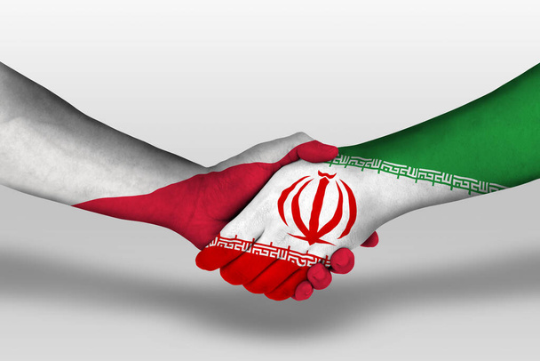 Handshake between iran and poland flags painted on hands, illustration with clipping path. - Фото, зображення