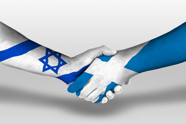 Рукопожатие между шотландскими и израильскими флагами, раскрашенными на руках, иллюстрация с вырезкой. - Фото, изображение