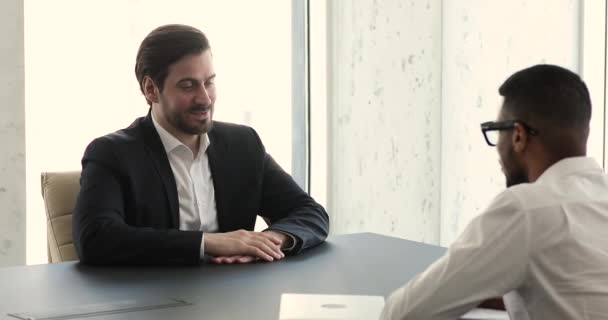 Applicant answers questions during job interview in company boardroom - Materiał filmowy, wideo