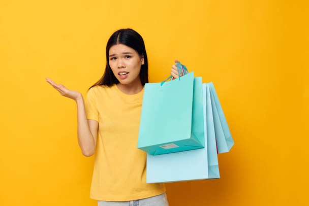 pretty brunette with packages in hands shopping isolated background unaltered - Foto, imagen