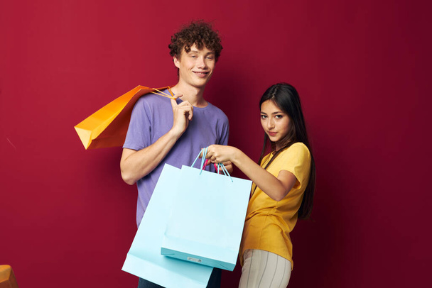 teenagers colorful bags shopping fun red background unaltered - Fotografie, Obrázek
