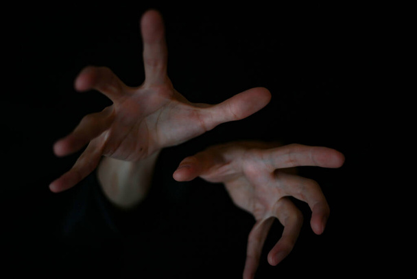 hands of a man on dark background - 写真・画像