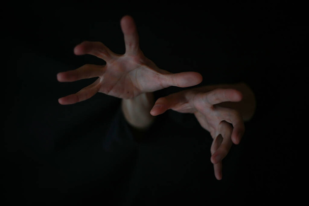 hands of a man on dark background - Fotó, kép