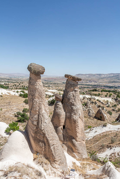 A Beautiful view of the valley of love in Cappadocia with mountain peaks in the summer day. Vertical - Fotoğraf, Görsel