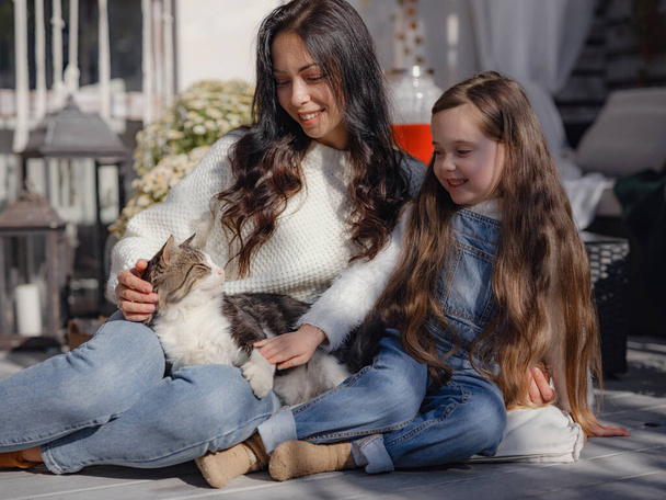 small happy family celebrating Thanksgiving. cute funny toddler and cat. Harvesting gifts autumn. countryside lifestyle. Parenthood small moments , hug and pet cat - Photo, Image