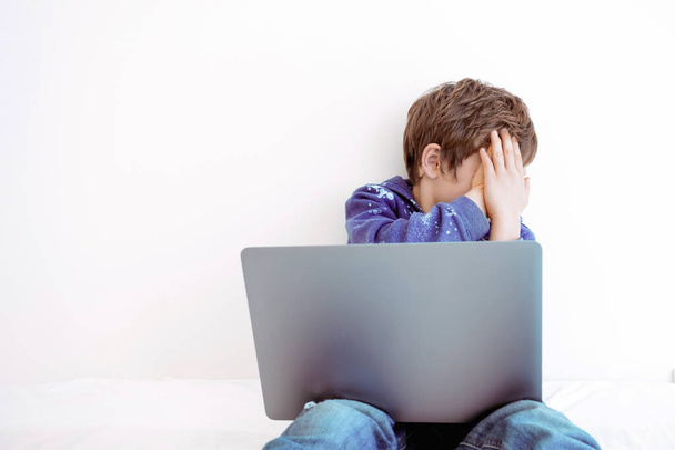 Boy sitting at laptop screen. Child using computer. Modern technology and children. Virtual reality - Photo, Image