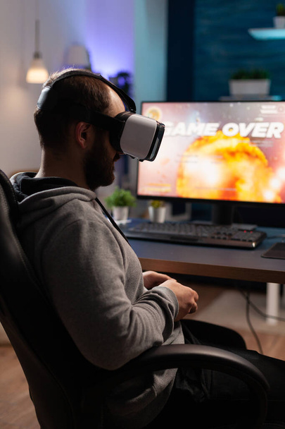Person wearing vr glasses to play video games with controller - Foto, afbeelding
