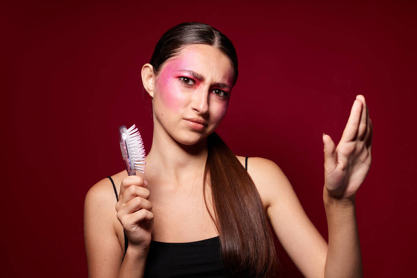 pretty woman pink face makeup posing attractive look with a comb close-up unaltered - Photo, Image