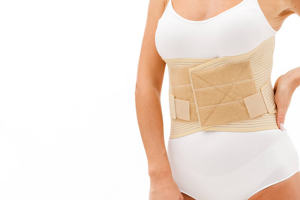 Orthopedic lumbar corset on the human body. Back brace, waist support belt for back. Posture Corrector For Back Clavicle Spine. Post-operative Hernia Pregnant and Postnatal Lumbar brace after surgery. - 写真・画像