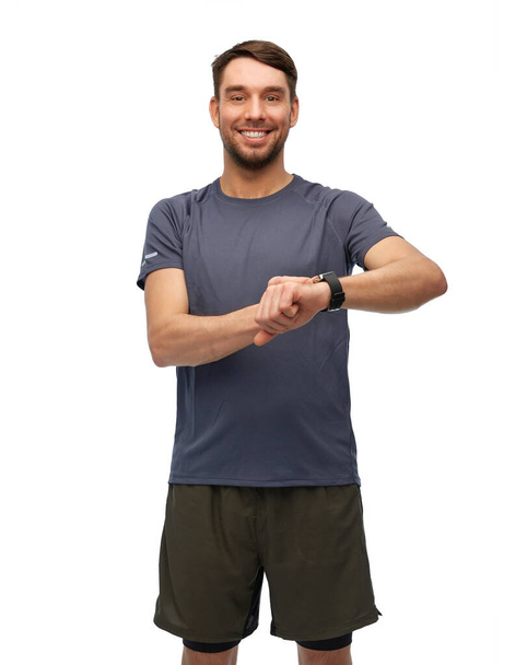smiling man with smart watch or fitness tracker - Zdjęcie, obraz