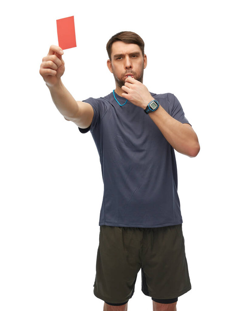 referee whistling whistle and showing red card - Foto, afbeelding