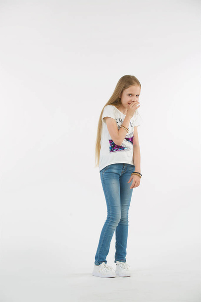 A teenage girl on a pure white background. Shy posture, fear. - Fotó, kép