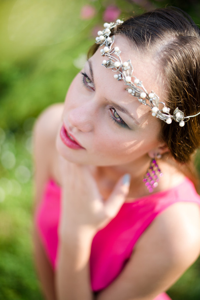 Woman wearing silver diadem looking up - Photo, Image