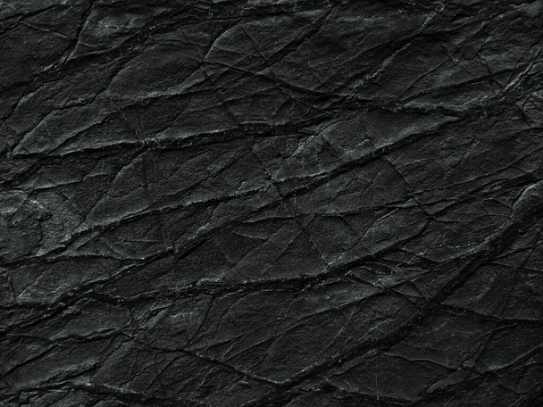     Black rock texture with cracks and veins. Close-up. Dark rough stone surface background for design.                           - Photo, Image