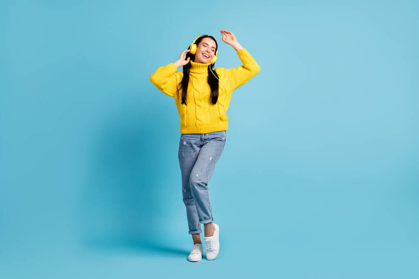 Full length bdoy size view of pretty dreamy cheerful girl listening audio having fun isolated over bright blue color background. - Photo, Image