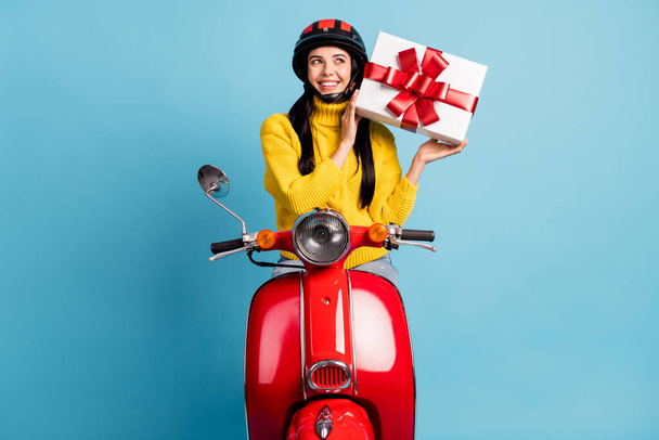 Photo portrait of young woman on retro bike trying to guess whats inside present box isolated vivid blue color background. - Фото, зображення