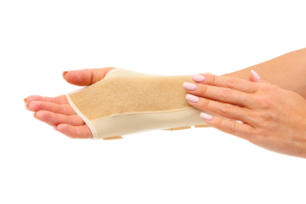 Retainer for a quick recovery and the pain in the wrist. A wrist brace is a garment that is worn around the wrist to protect it during strong use or for allowing it to heal. - Photo, Image