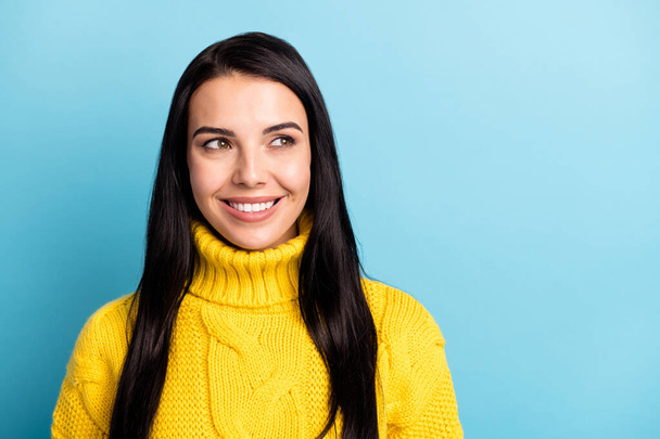 Photo portrait of curious dreamy girl wearing yellow knitted sweater looking on blank space isolated on vivid blue color background. - Фото, изображение