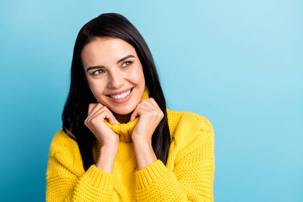 Portrait of attractive cheerful dreamy girl wearing cosy clothes copy space isolated over bright blue color background - Fotoğraf, Görsel